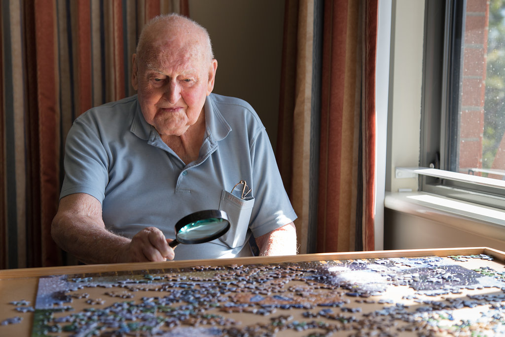 Man completing puzzle